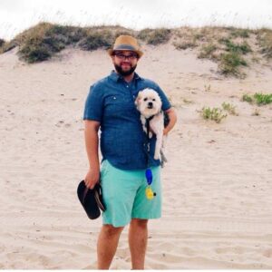 Front Desk Manger Dan at the beach with his dog