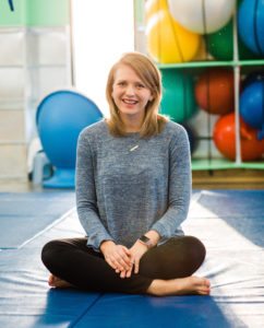 Brittni Winslow, executive director of Emerge Pediatric Therapy seated in sensory gym