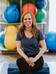 Speech Language Pathologist and Clinical Director of Speech Language Therapy Kelly sitting in the Sensory Gym