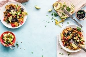 three fruit salads in plates and a cutting board