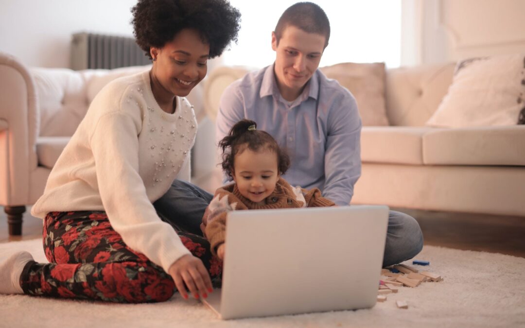 photo-of-family-sitting-on-floor-while-using-laptop-3818963