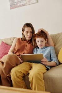 mother and son looking at a tablet together