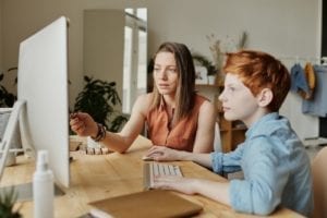 mother teaching her son on the computer