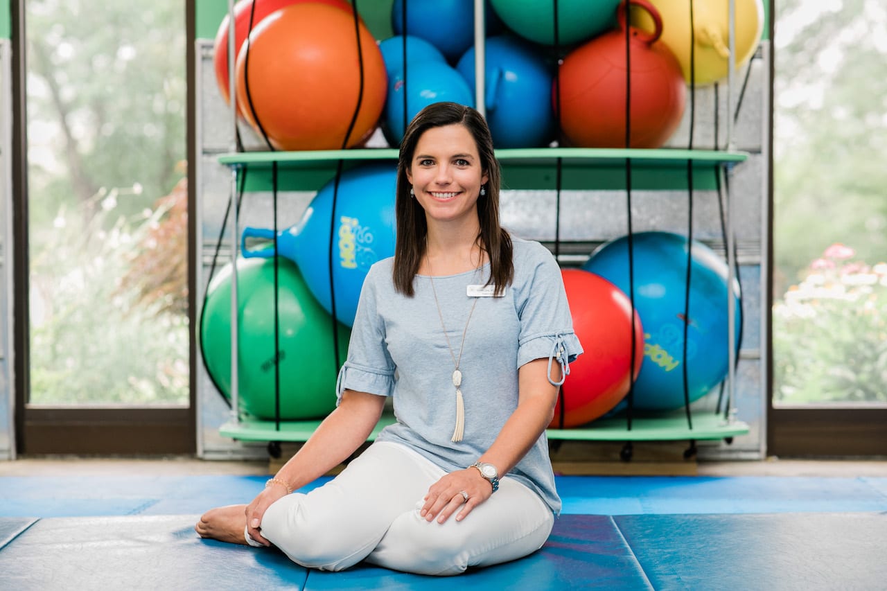 Speech Language Pathologist Danielle, seated in the Sensory Gym