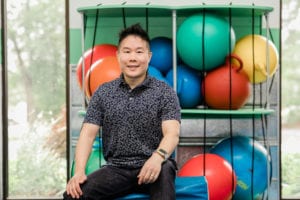 Occupational Therapist Taz sitting in the sensory gym