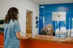 Receptionist greeting a guest at Emerge Pediatric Therapy