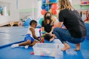 Two Female therapist working with a child in a Sensory Gym