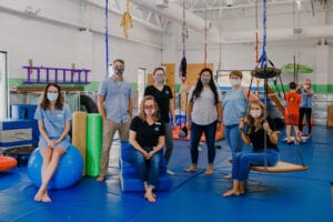 Emerge Pediatric Therapy Staff posing while all wearing masks, in the Sensory Gym