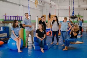 Emerge Pediatric Therapy Staff posing and interacting in the Sensory Gym