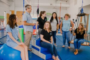 Emerge Pediatric Therapy Staff posing and interacting in the Sensory Gym