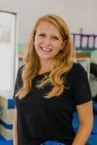 EXECUTIVE DIRECTOR Brittni smiling in the Sensory Gym