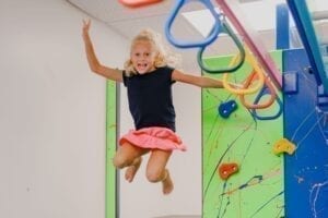 Young girl jumping into the foam pit