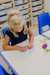 Girl practicing hand writing and visual motor skills in the Fine Motor Room