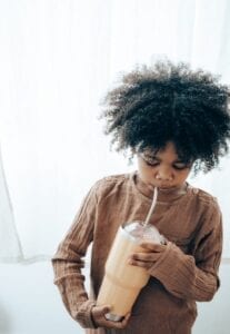 young child drinking from a straw