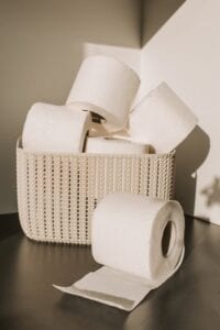 white braided basket of toilet paper