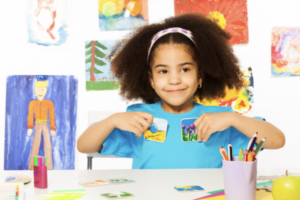 little girl holding cards with flowers and water