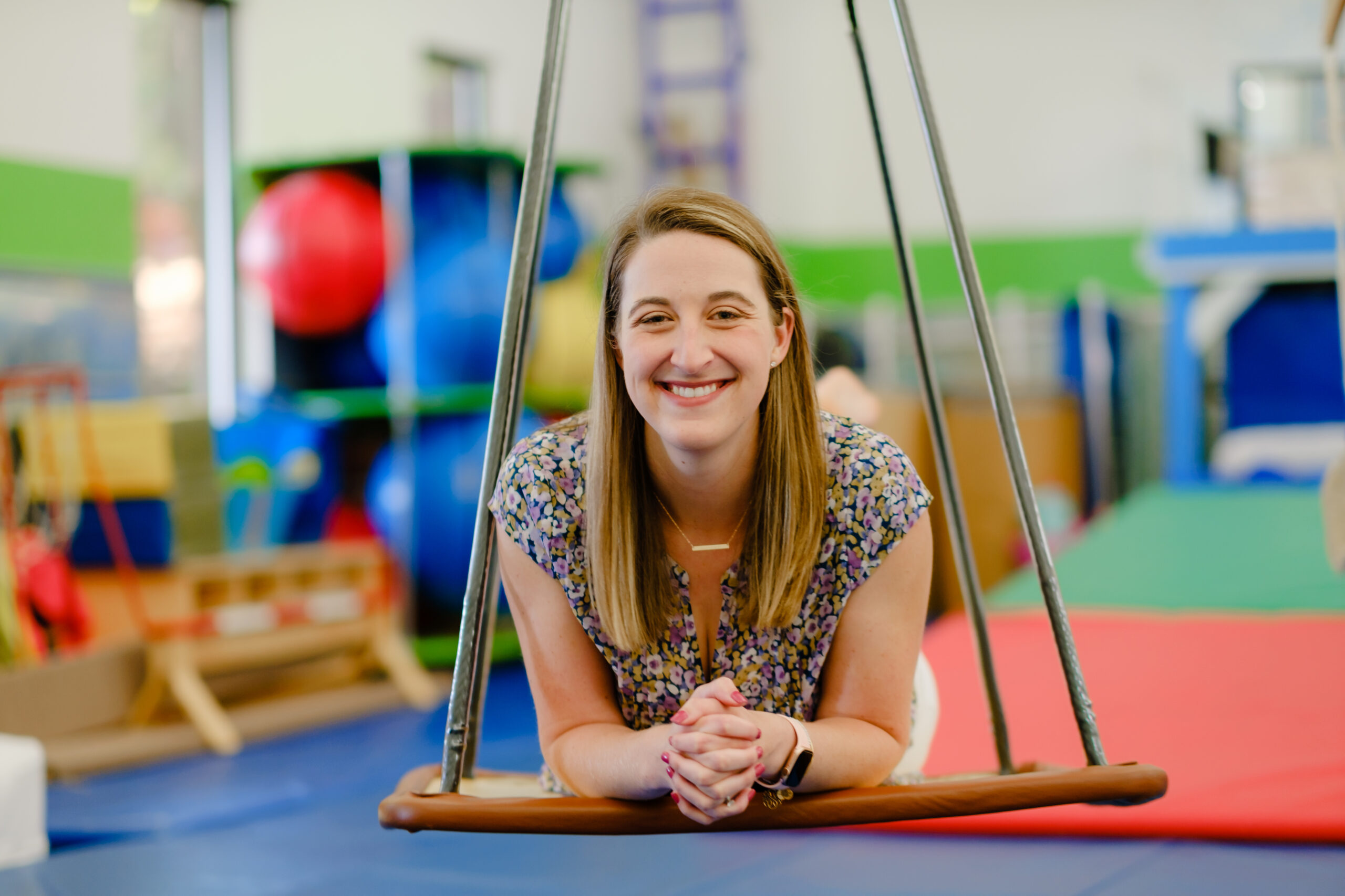 EXECUTIVE DIRECTOR Brittni smiling in the Sensory Gym