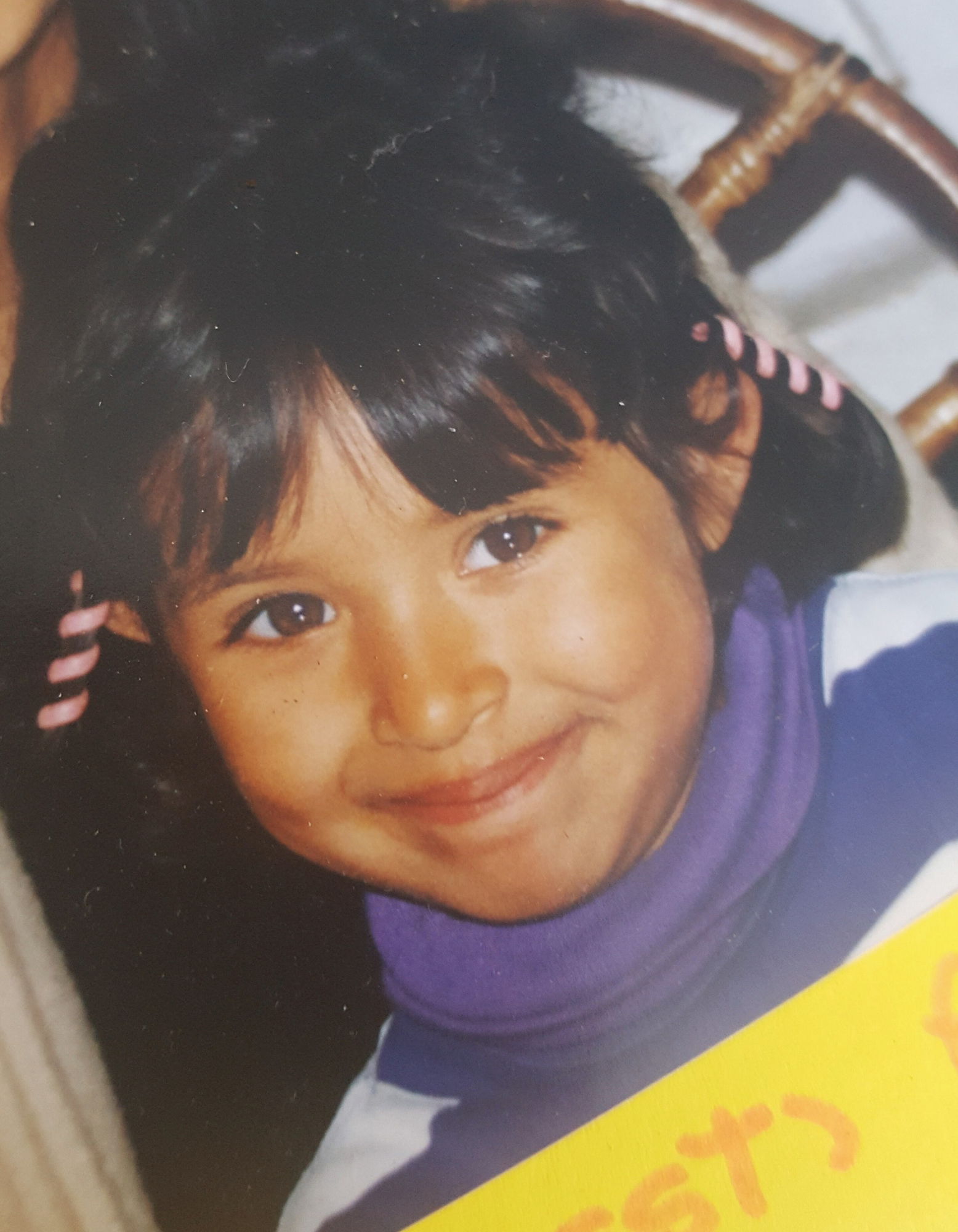 Speech Language Pathologist Laura Strenk as a girl, wearing a purple sweater with toy jewelry