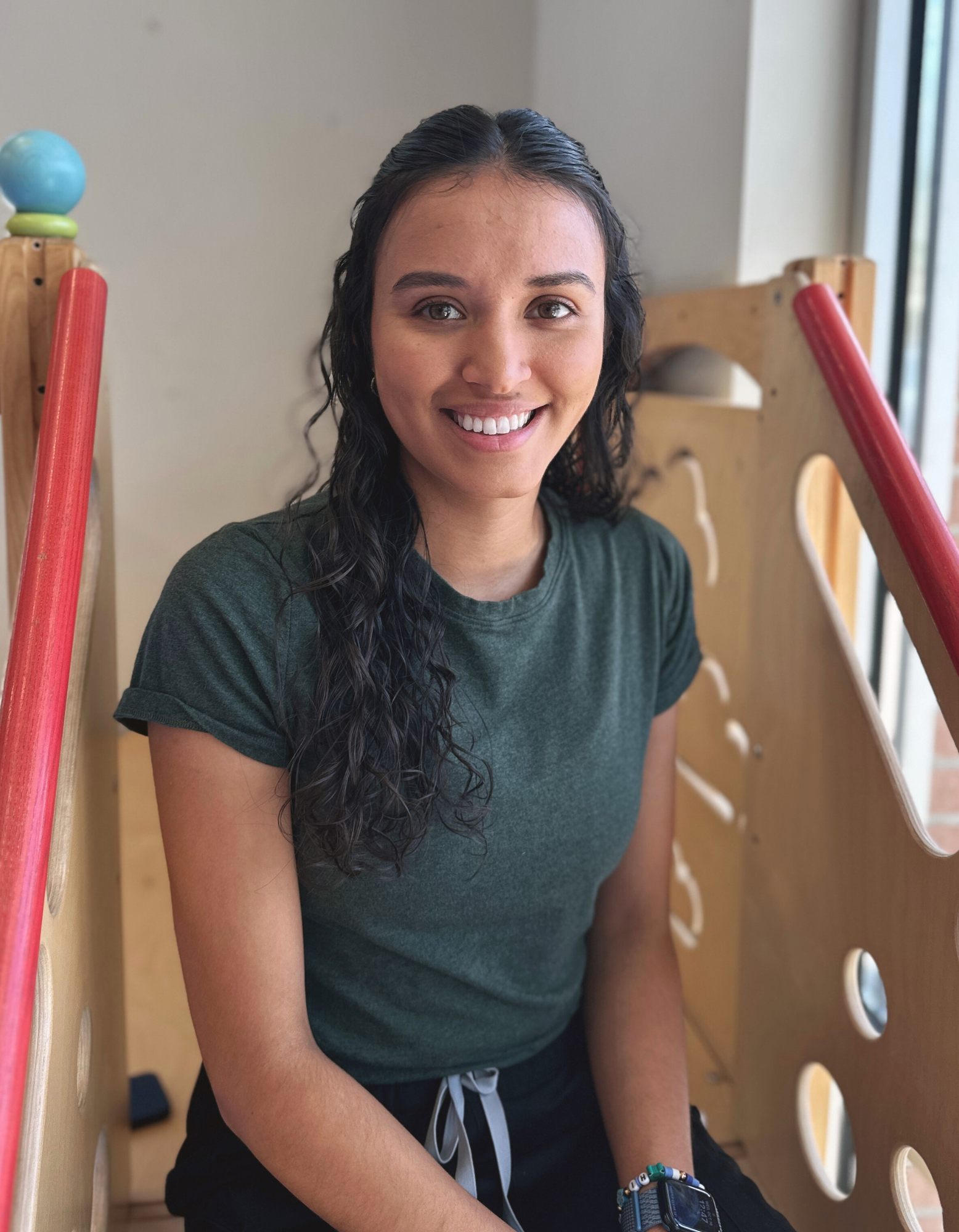 Speech Language Pathologist Laura sitting in sensory gym