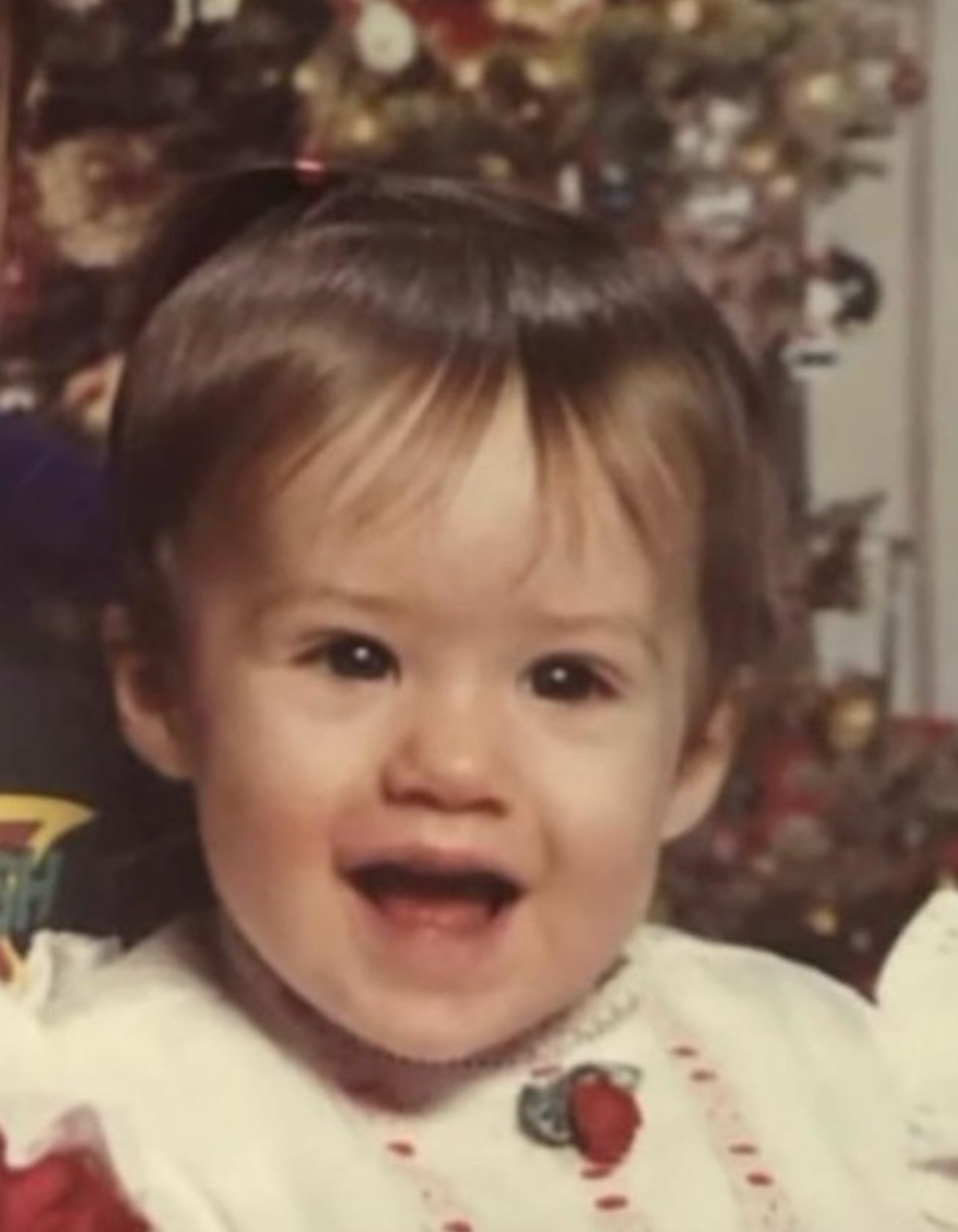 whitney baby picture Speech Language Pathologist Laura Strenk as a girl, wearing a purple sweater with toy jewelry