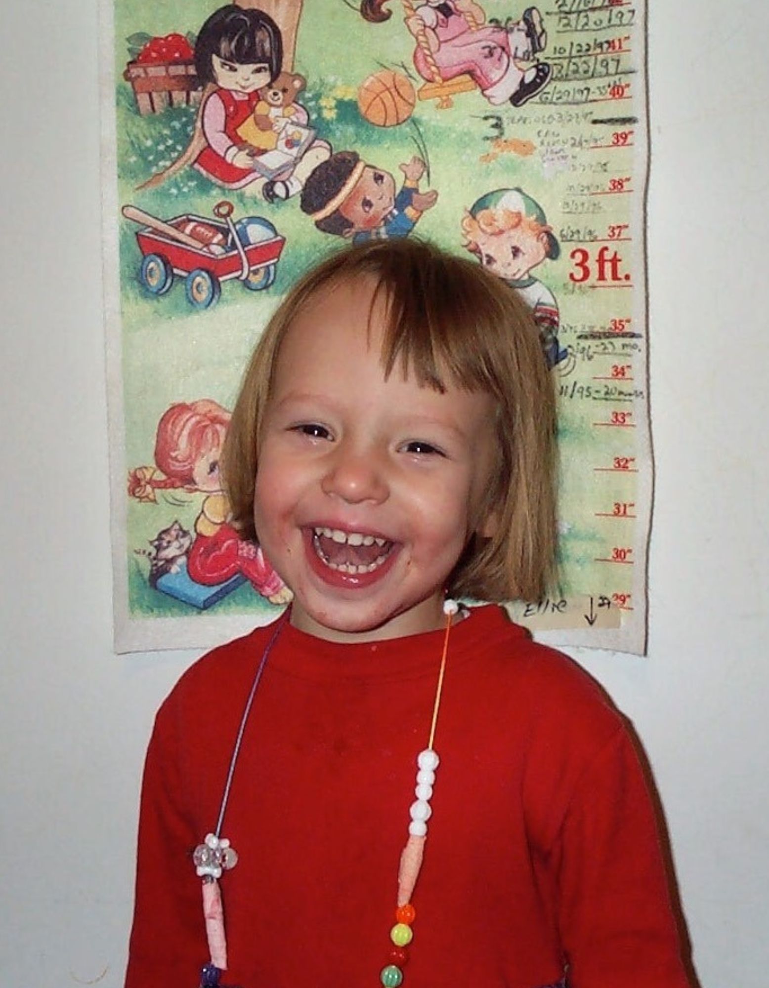 Speech Language Pathologist Laura Strenk as a girl, wearing a purple sweater with toy jewelry