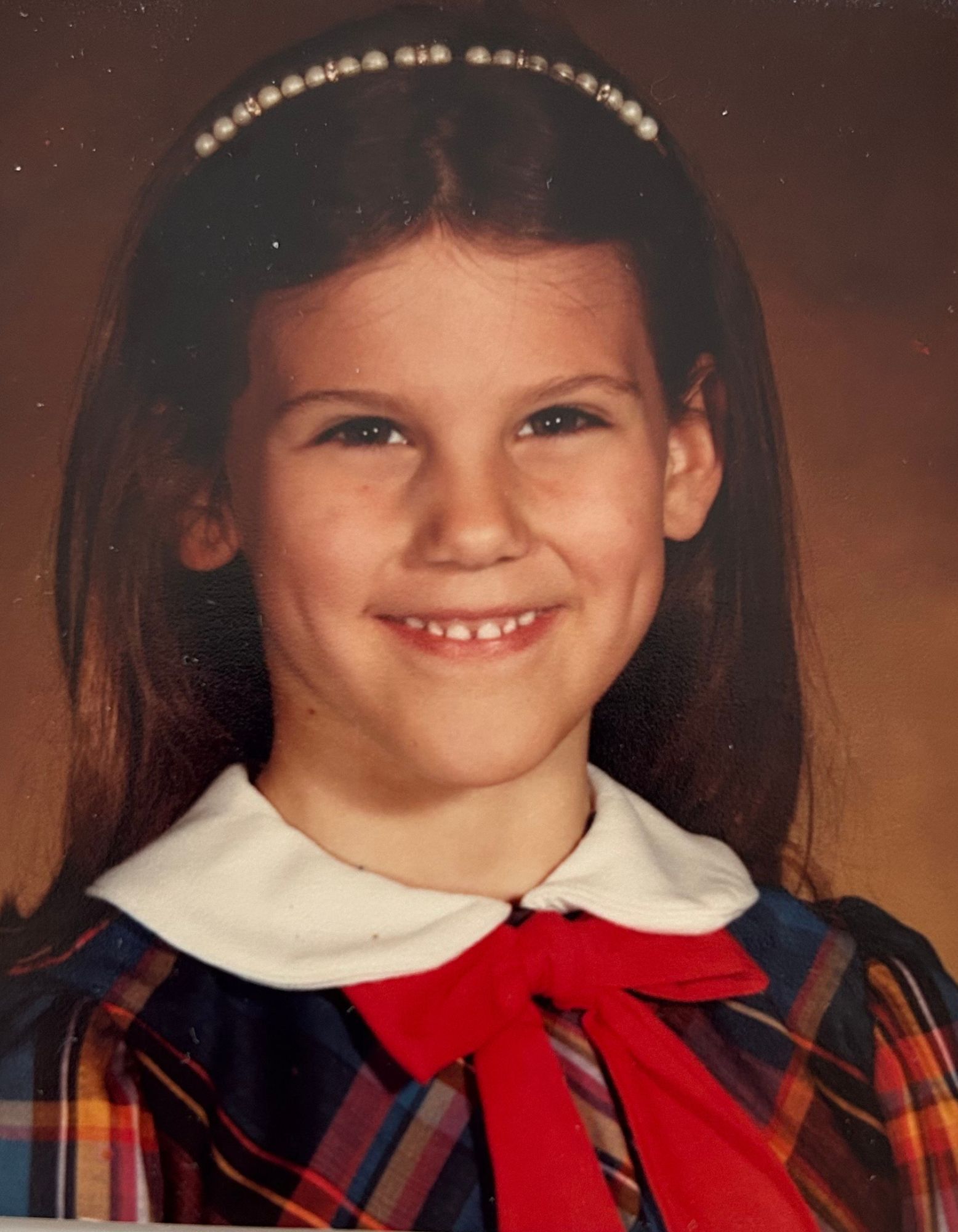 Occupational Therapist Andrew Klein as a young boy sitting at a table with a workbook
