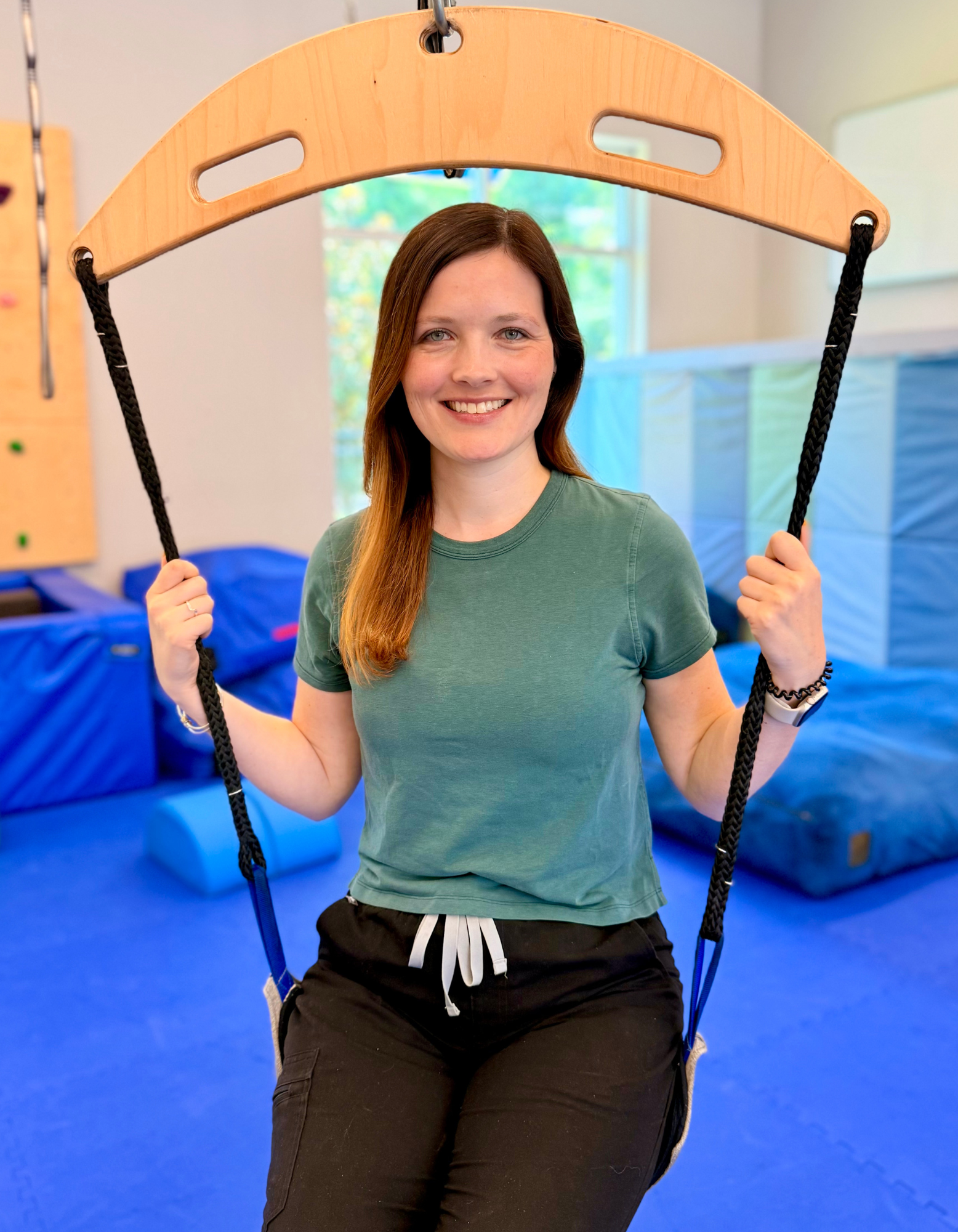 Occupational Therapist Andrew Klein inside a tunnel swing in the sensory gym