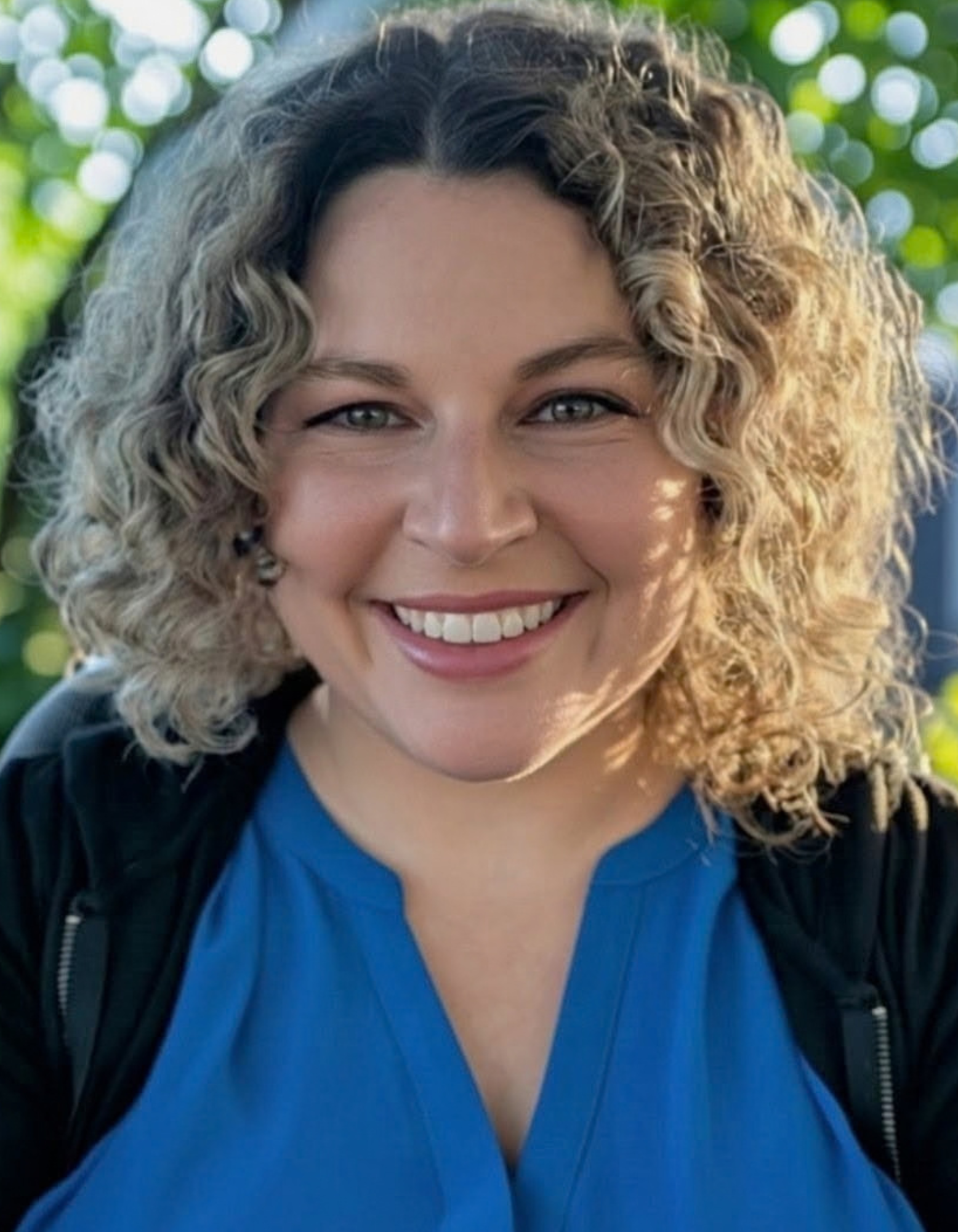 EXECUTIVE DIRECTOR Brittni smiling in the Sensory Gym